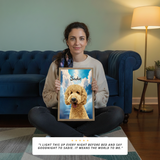 Woman holding a framed picture of a dog named Sadie in a living room.