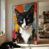 Living room with a large abstract painting of a black and white cat, and a real black and white cat sitting in front of it.