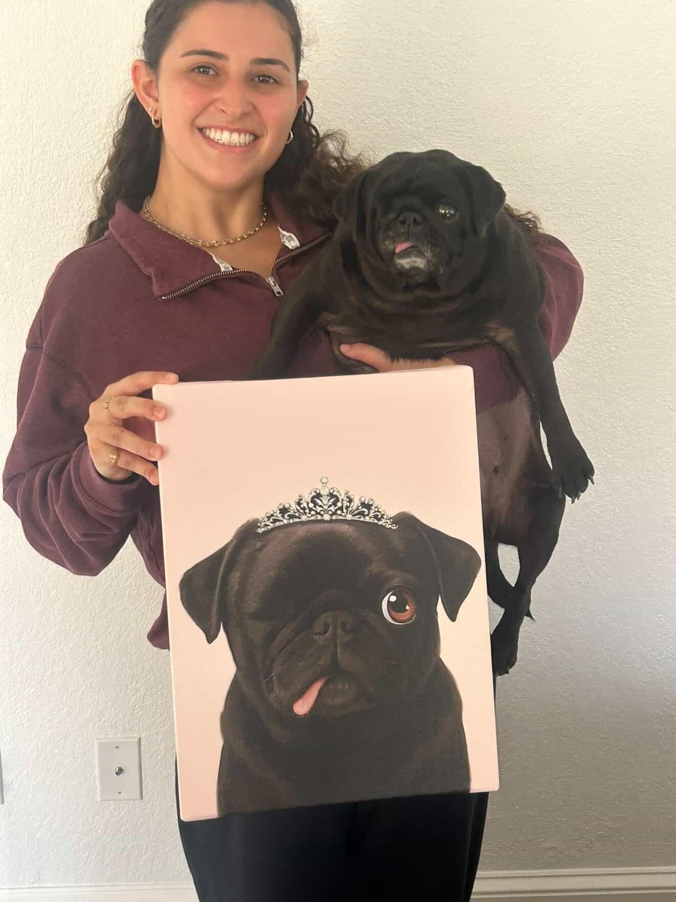 Maya holding her pug Princess and the Bondel canvas with tiara