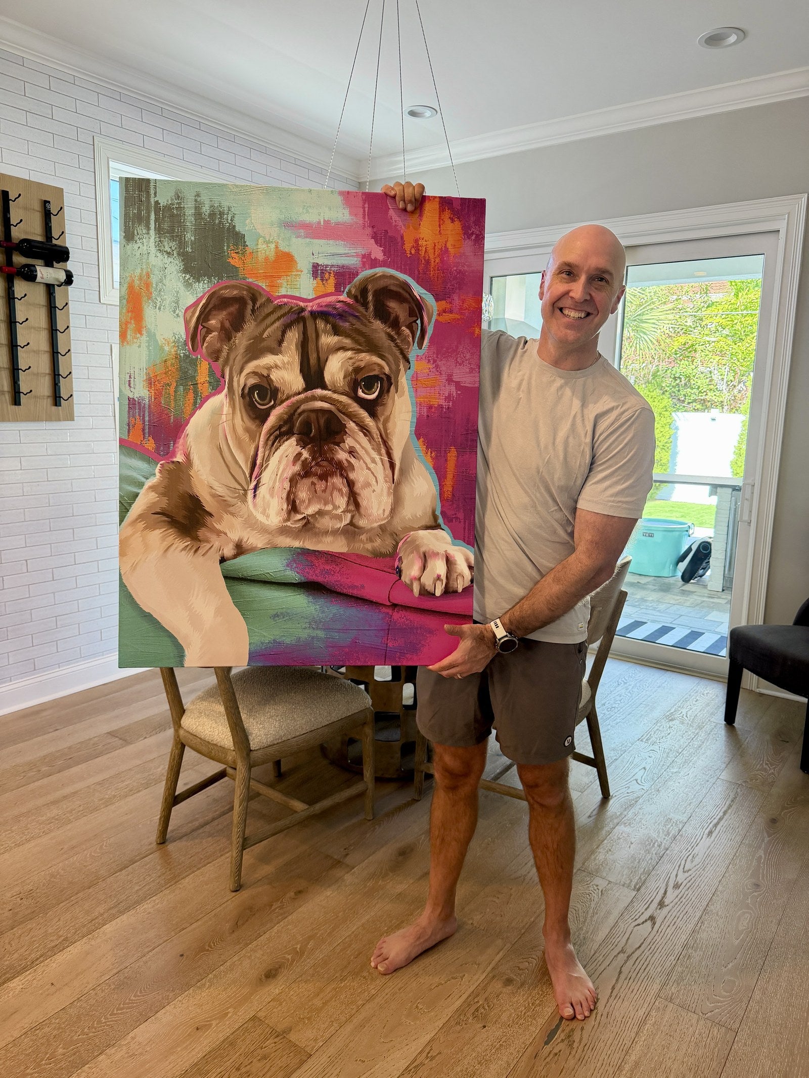 Mike holding the Bondel pop-art canvas of his bulldog Bruno